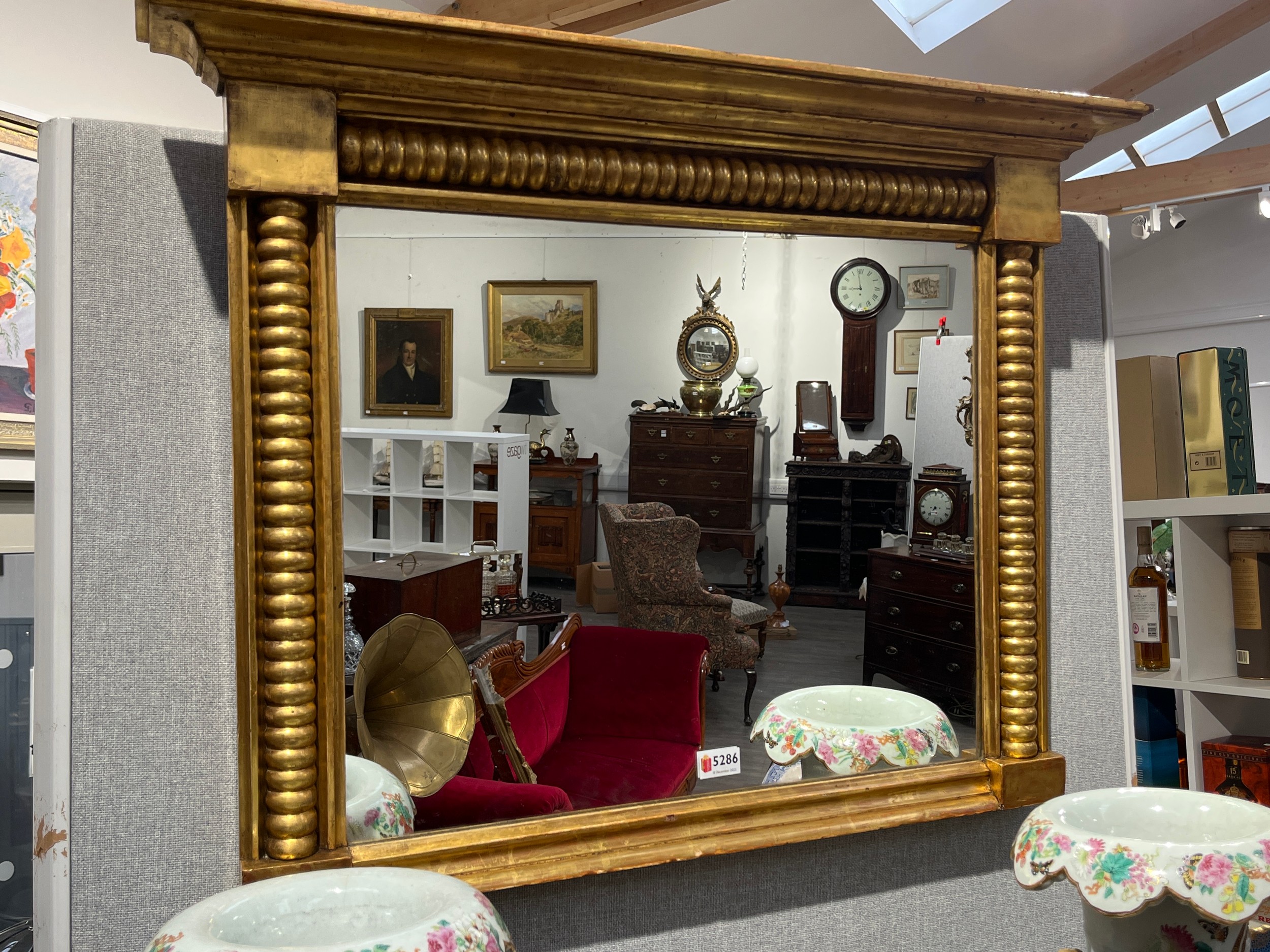 A 19th Century giltwood wall hanging mirror with bobbin turned decoration, 65cm x 83cm