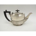 A Fredrick Wilson & Co., silver teapot with melon fluting, ebony treen knop and handle, Sheffield