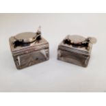 Two travelling glass inkwells with silver tops, a/f