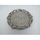 A George II William Peaston silver waiter with repousse floral border, London 1754, 17.5cm diameter,