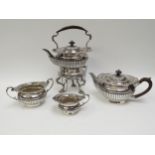 A Goldsmiths & Silversmiths Co., silver four piece tea set comprising spirit stand with kettle,