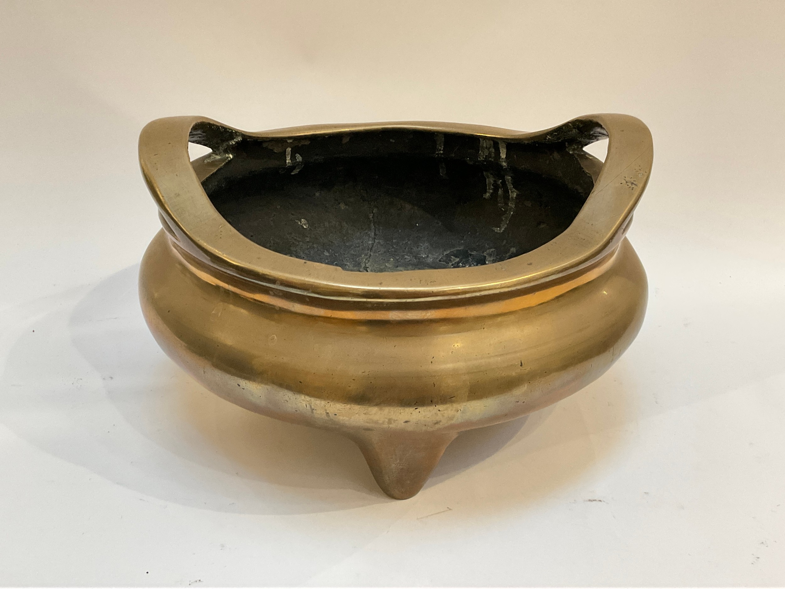 A Quing dynasty (1644-1911) Chinese large bronze two-handed censer bowl of cushioned shallow