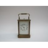 An early 20th Century brass carriage clock with repeat mechanism, plain white face, 14.5cm tall