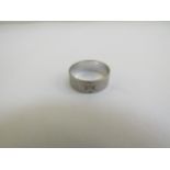 An 18ct white gold band, floral engraved, 6mm wide. Size L, 3.5g