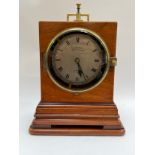 A Victorian watchman's shelf clock, dial marked Clerke, 1 Royal Exchange, London. Heavy brass