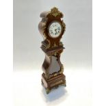 A 19th Century French timepiece as a miniature Continental style long case clock with brass mounts