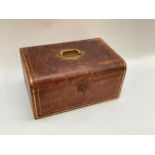 An early 20th Century leather jewellery box with brass fittings and gilt tooling, velvet lined