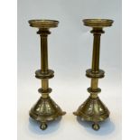 A pair of Arts and Crafts ecclesiastical brass pricket stands with trefoil decoration, 34.5cm tall