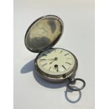 An English silver pocket watch with black Roman numerals to the white enamel face, the movement