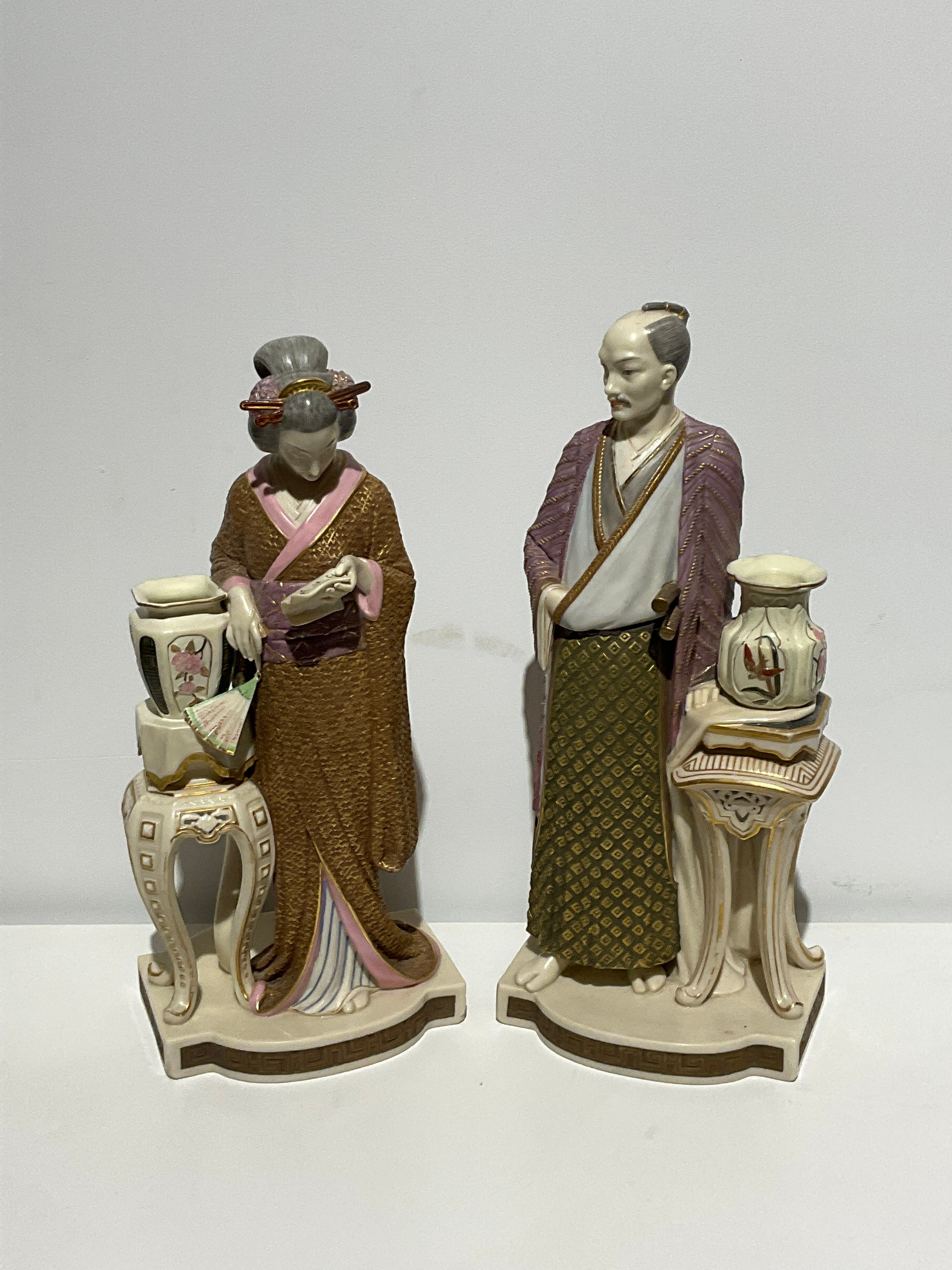 A large pair of Royal Worcester figures - a standing Japanese man and woman, designed by James
