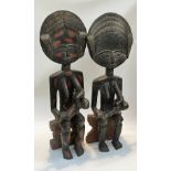 A pair of Northern Ghanaian carved wood fertility figures, standing 90cm and 92cm tall