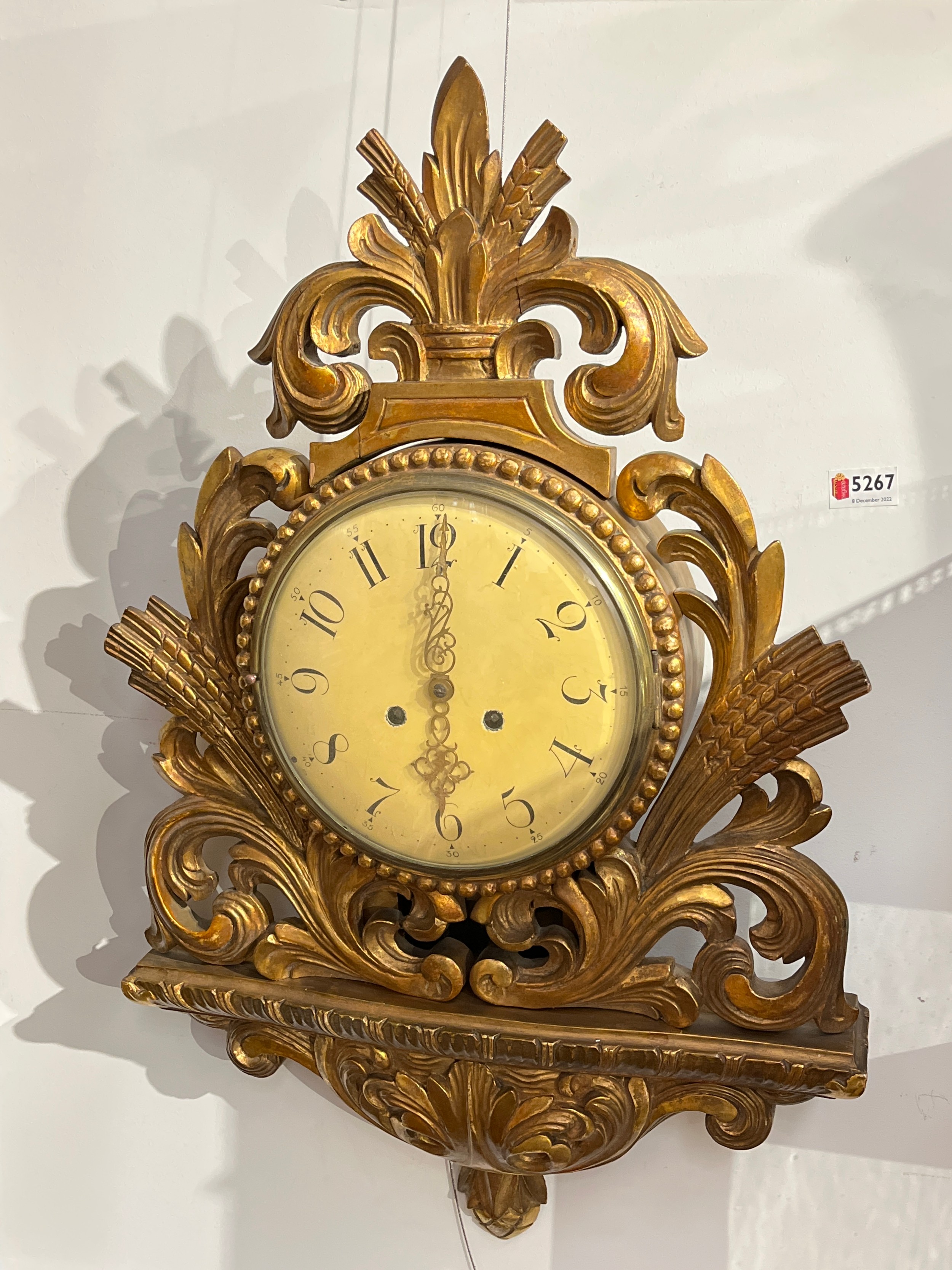A 19th Century French cartel clock with Arabic numerals to the cream face, within a gilded