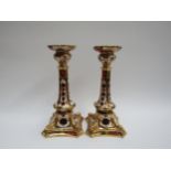 A pair of Royal Crown Derby 1128 Imari pattern candlesticks, 27cm tall