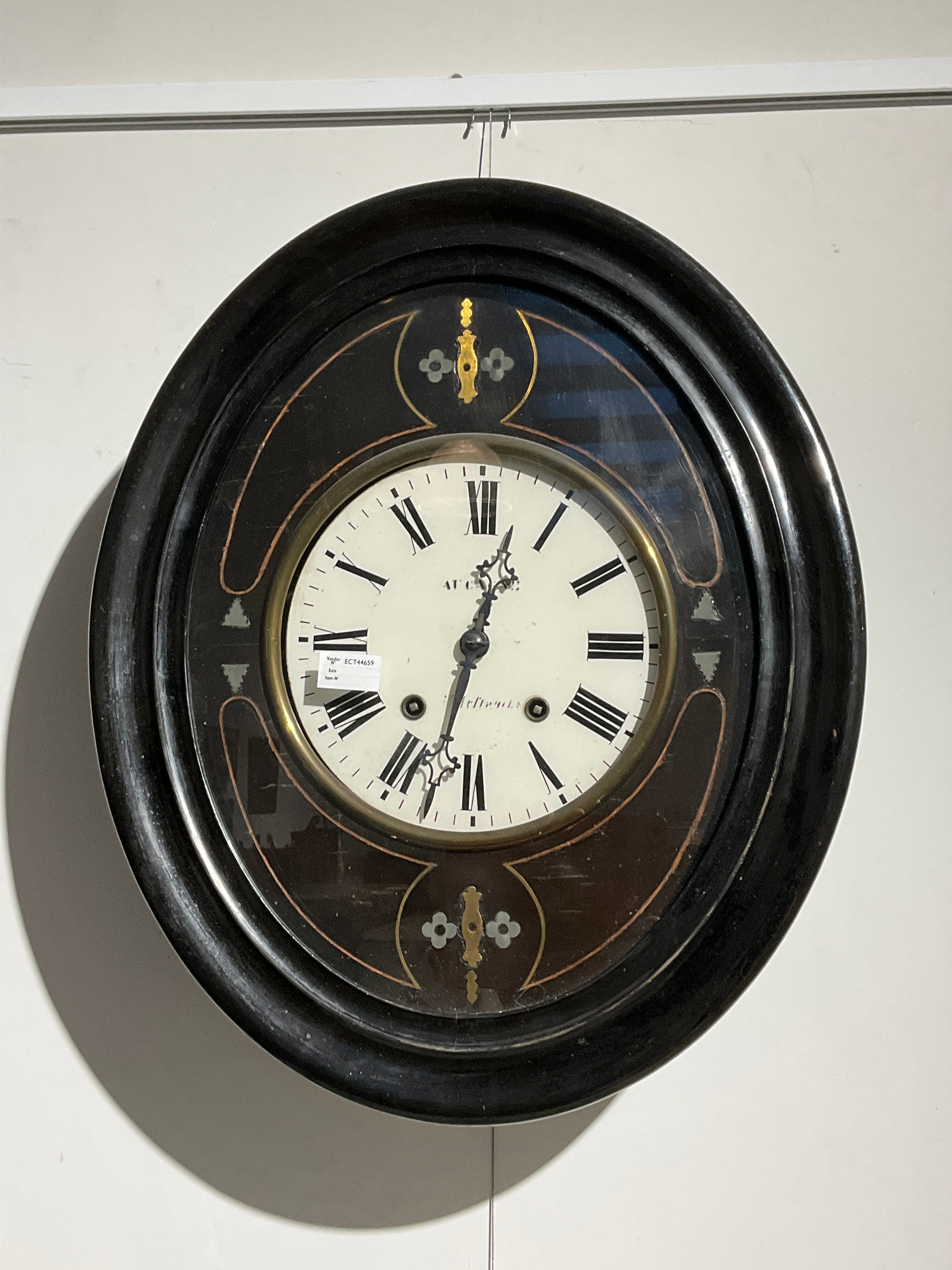 A 19th Century French vineyard clock, ebonised case, oval form