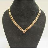 A three tone gold woven necklace stamped 9k, 6.8g