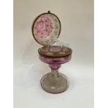 A Victorian cranberry and frosted glass liquor stand decorated with enamels