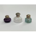Three miniature glass scent bottles / vinaigrettes including amethyst glass and white thumb cut