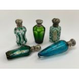 Five various glass scent bottles including etched and cut glass, one enriched with gilt