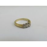 An 18ct gold three stone diamond ring. Size L, 3.4g