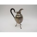A Continental silver jug raised on three hoof feet, base marked 800, possibly Spanish, 14cm tall,