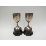 A pair of James Walter Tiptaft silver trophies, Birmingham 1933, dented and on restored, 12.5cm