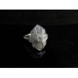 An Art Deco style diamond encrusted ring, unmarked white metal shank. Size T/U, 4.7g