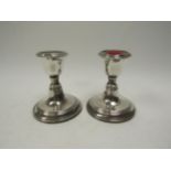 A pair of William Aitken silver candlesticks with reeded band detail, Birmingham 1919, weighted