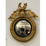 A late 18th/early 19th Century highly ornate gilt circular cover wall mirror with seahorse and