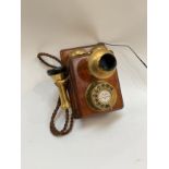 An early 20th Century mahogany and brass wall telephone