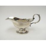A Victorian silver cream jug with S-Scroll handle, marks rubbed, 7.5cm tall, 13.5cm long, 111g