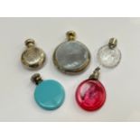 Five various scent bottles including silver with guilloche detail, together with cranberry glass