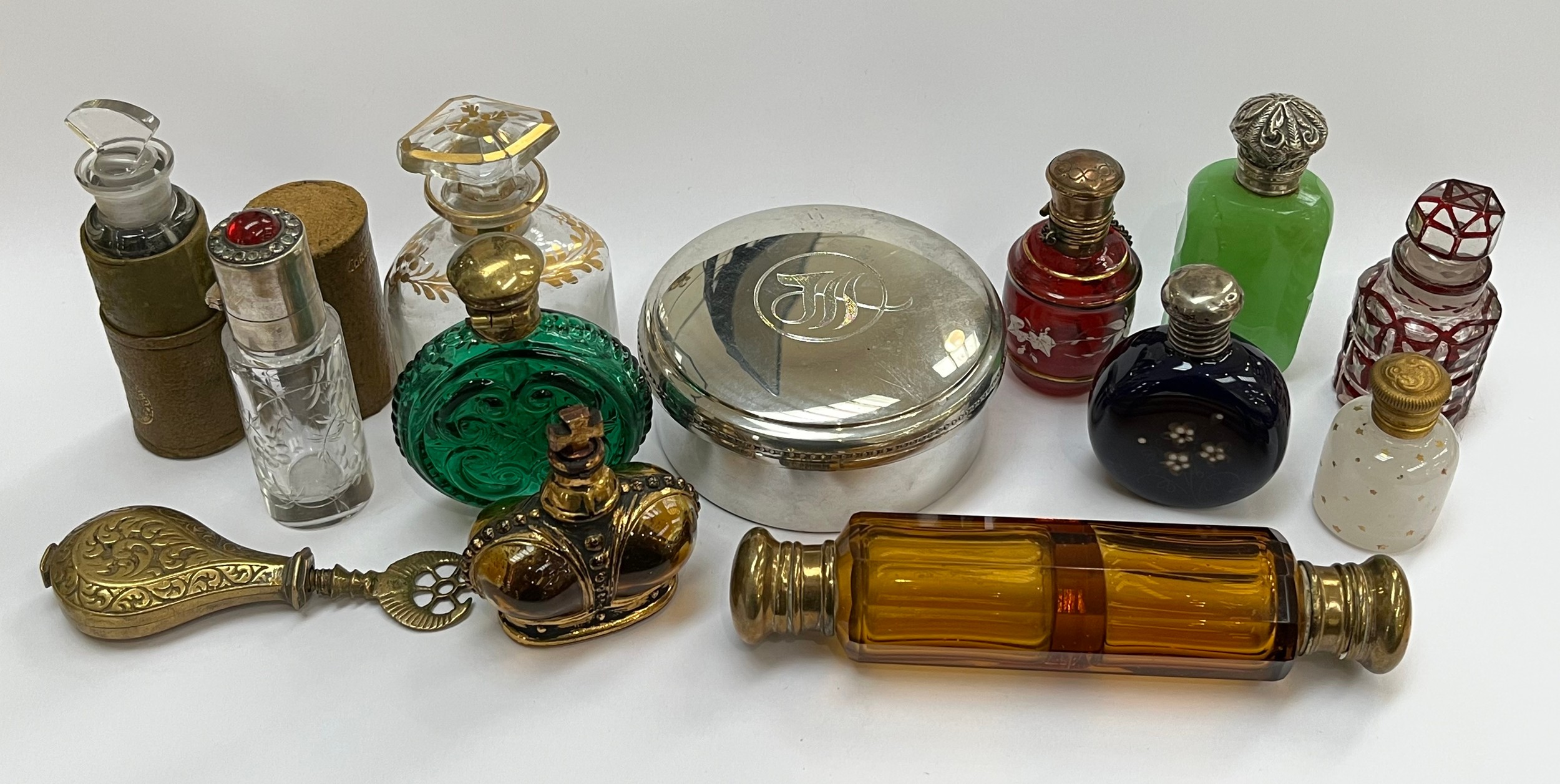 A collection of scent bottles including amber glass double-ended and gilt enriched, together with