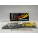 Three Perspex cased Scalextric slot racing cars to include Porsche GT1 (crack to case), C2424 Ford