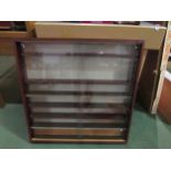 A display cabinet with glass sliding doors, 80cm tall x 80cm wide x 10cm deep