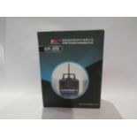 A boxed Fly Sky FS-T4B radio control system