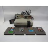An unboxed Nintendo Entertainment System NES version computer games console with two controllers and