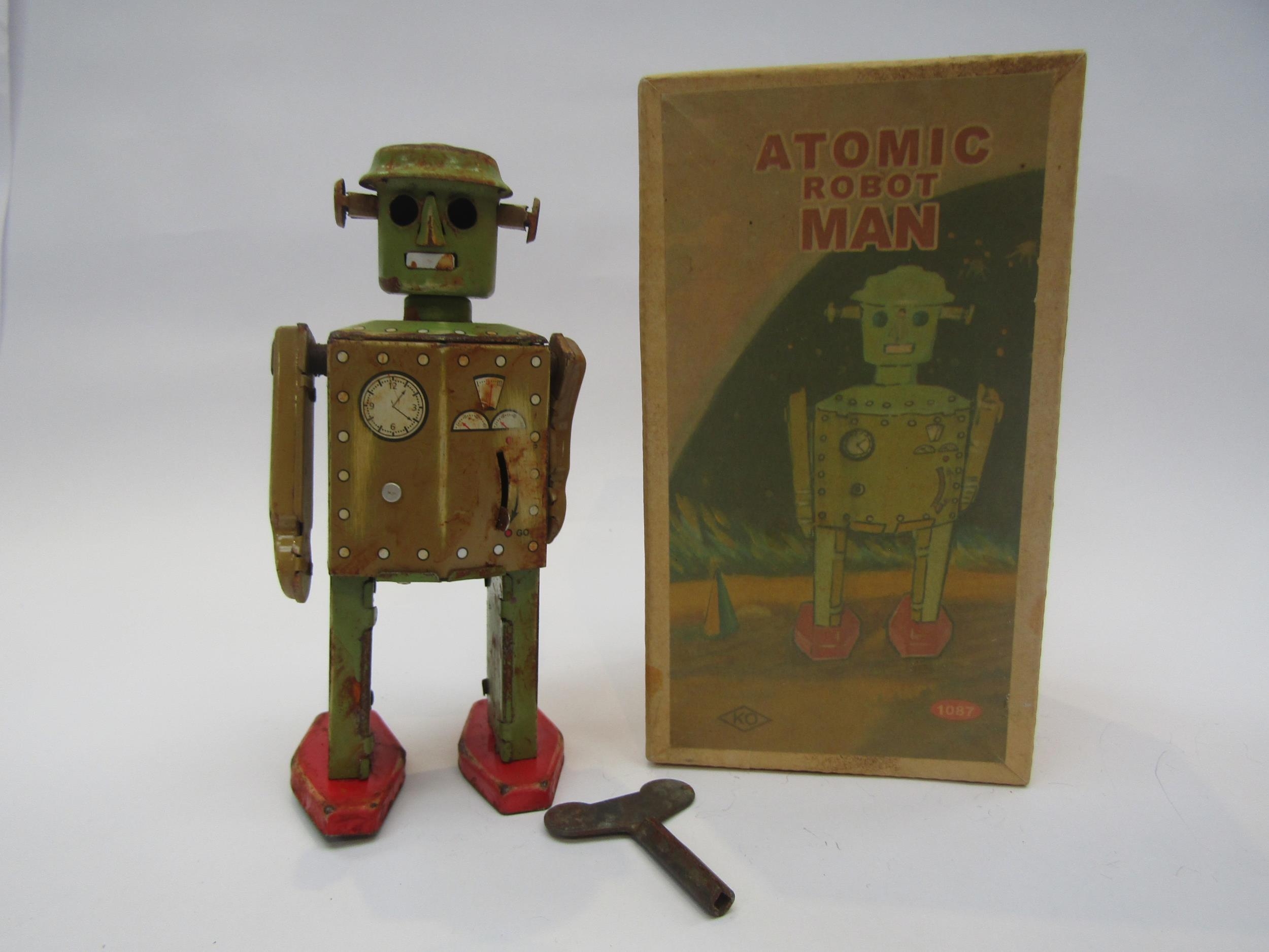 A boxed reproduction Atomic Robot Man tinplate clockwork robot, water damaged