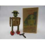 A boxed reproduction Atomic Robot Man tinplate clockwork robot, water damaged