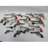 A collection of playworn toy guns, cap guns and pistols including Hubley, Lone Star, Wicke etc