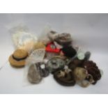 Assorted doll parts including glass eyes, wigs, hats, clothing patterns, limbs, etc
