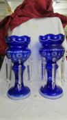 A pair of blue glass overlaid lustre's, (two droppers a/f and one dropper missing). 36 cm tall.
