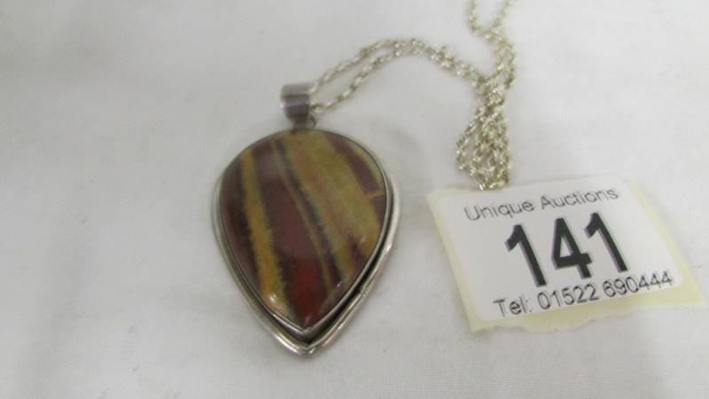 A jasper stone pendant in a silver mount in a heart design on an attached silver chain. - Image 2 of 2