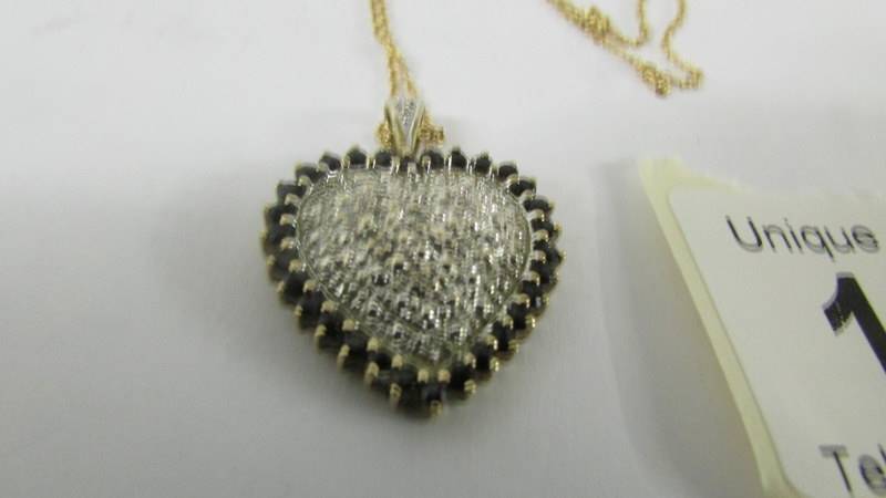 A yellow gold heart pendant on a 9ct gold chain. - Image 6 of 7