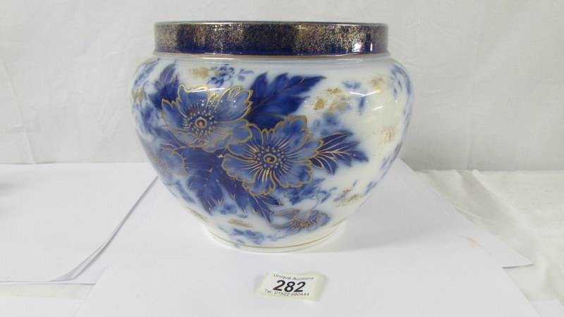 A Victorian blue, white and gilded jardiniere. Height 19cm. Diameter 25cm.
