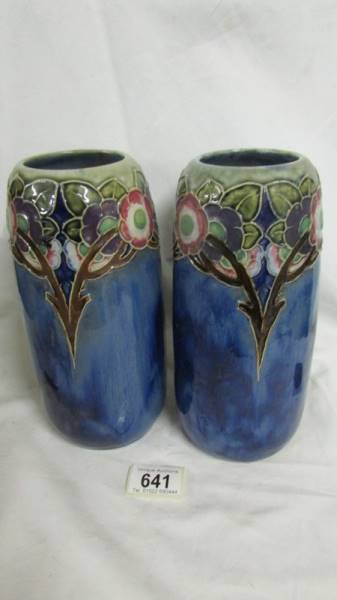 A pair of Royal Doulton blue ground vases, 23 cm tall. Collect only.