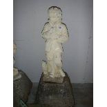 An old garden figure of a boy on base, in good condition for age.