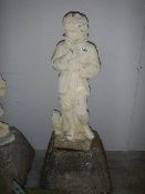 An old garden figure of a boy on base, in good condition for age.