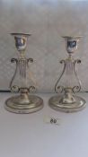 A pair of lyre shaped silver candlesticks. Sconces present, height 20cm, base 11.5cm x 9cm, some