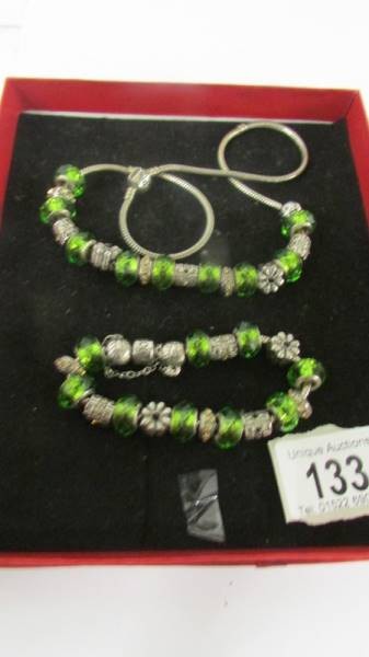 A Pandora necklace and bracelet with nine silver charms on each (925).
