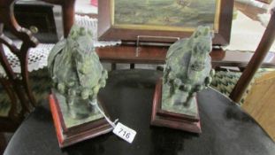A pair of jade horses on stands.